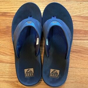 Men’s Reef slip-on sandals w/ bottle opener on bottom.